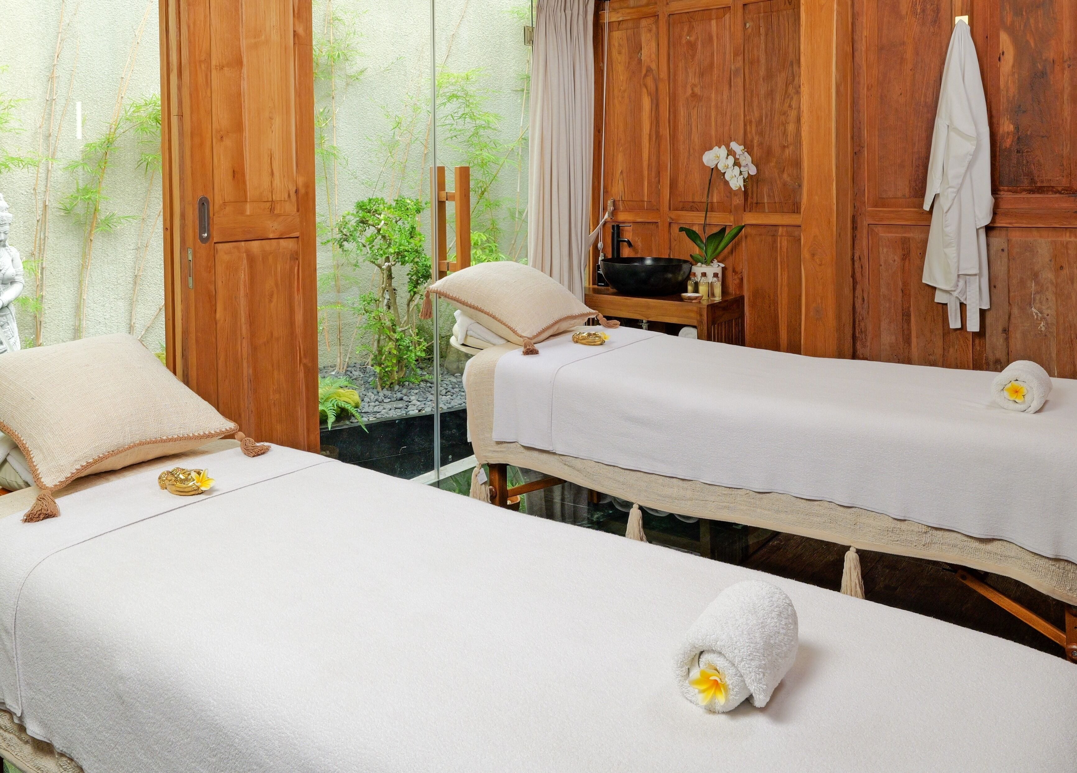 Relaxing massage beds at Hidden Gem Spa Uluwatu, Bali, Bali, ID with calming decor and natural light.