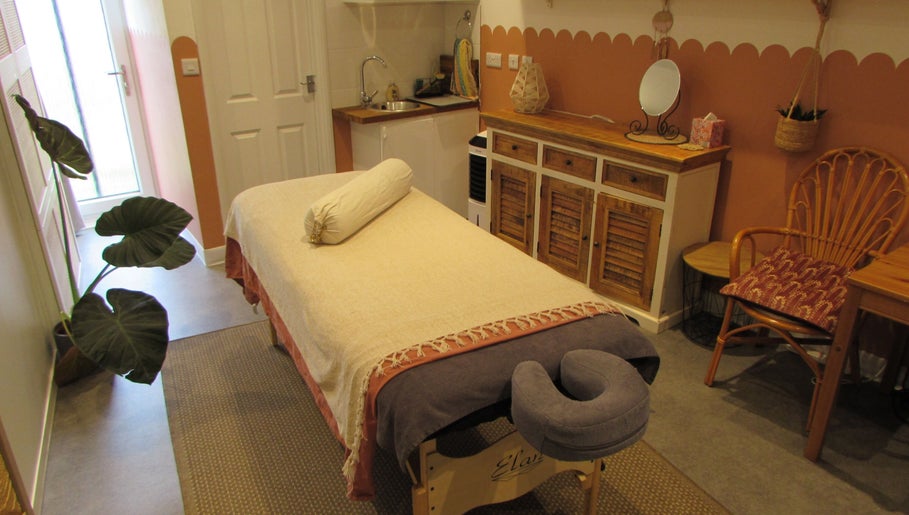 Calm therapy room at Laura Jane Holistic in Bristol, England, GB with massage table and warm decor.