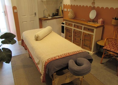 Calm therapy room at Laura Jane Holistic in Bristol, England, GB with massage table and warm decor.