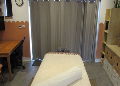 Relaxing treatment room at Laura Jane Holistic, Bristol, England, GB, featuring a cozy massage table and warm decor.