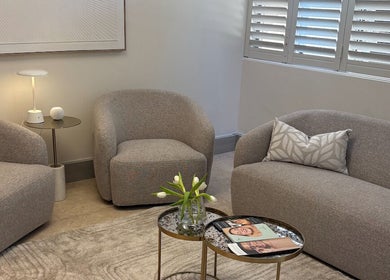 Inviting seating area at The Dermal Collection, Cape Town, Western Cape, ZA, with chic armchairs and sofa.