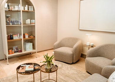 Cozy lounge area of The Dermal Collection, Cape Town, Western Cape, ZA with elegant seating and product display.