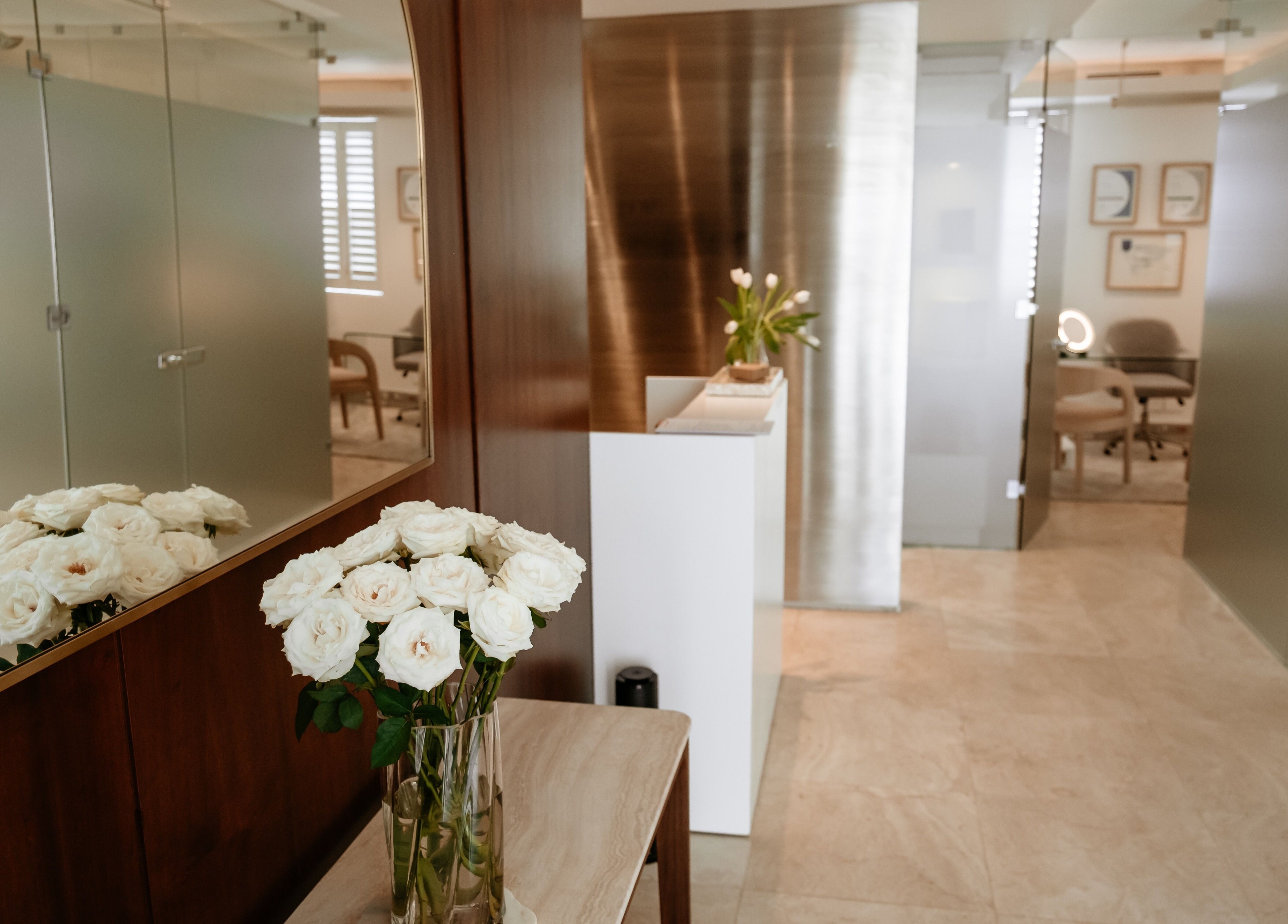 Welcoming entrance at The Dermal Collection in Cape Town, Western Cape, ZA, featuring fresh white roses.