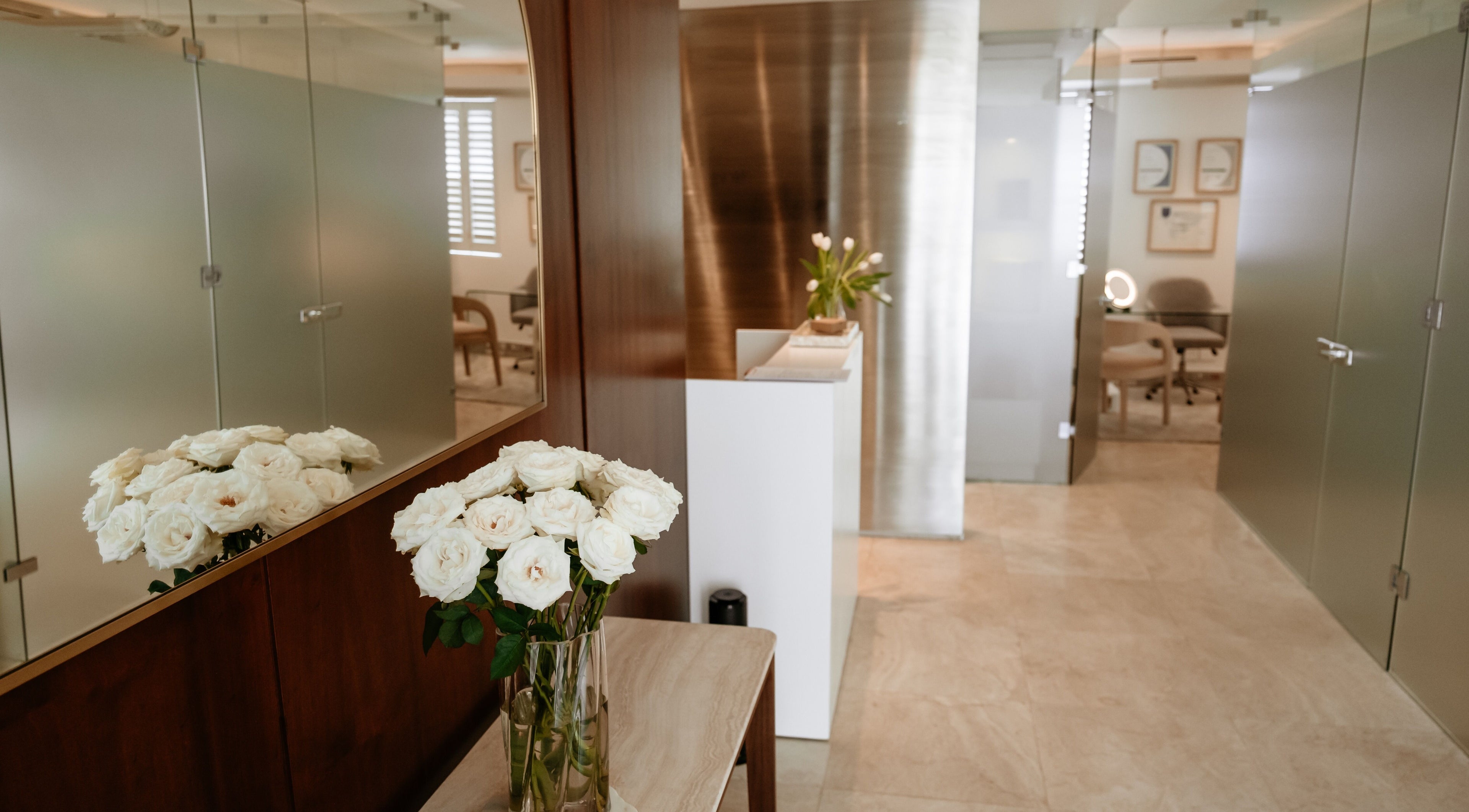 Welcoming entrance at The Dermal Collection in Cape Town, Western Cape, ZA, featuring fresh white roses.