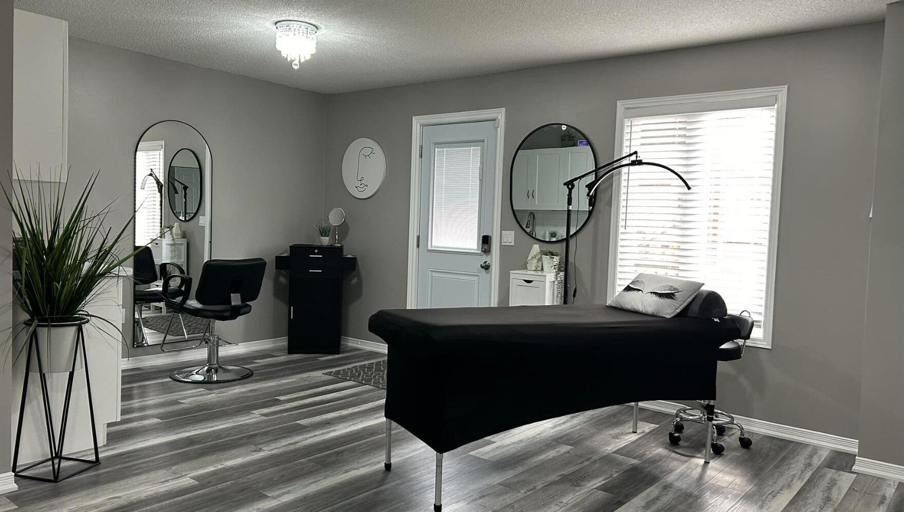 Modern aesthetic room at Endulgence Esthetics, London, Ontario, CA, featuring sleek styling chair and treatment bed.