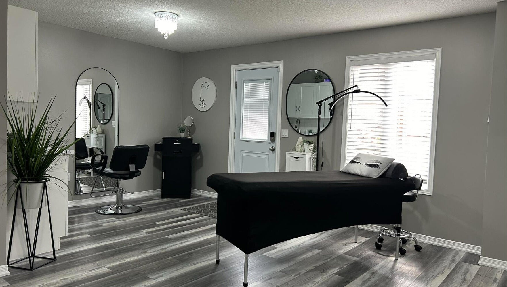 Modern aesthetic room at Endulgence Esthetics, London, Ontario, CA, featuring sleek styling chair and treatment bed.