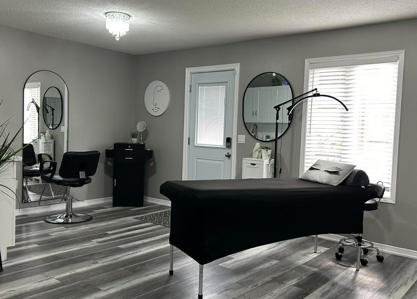 Modern aesthetic room at Endulgence Esthetics, London, Ontario, CA, featuring sleek styling chair and treatment bed.