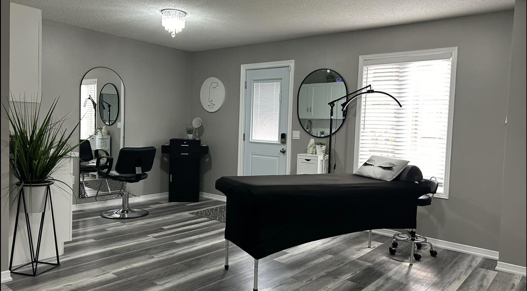 Modern aesthetic room at Endulgence Esthetics, London, Ontario, CA, featuring sleek styling chair and treatment bed.