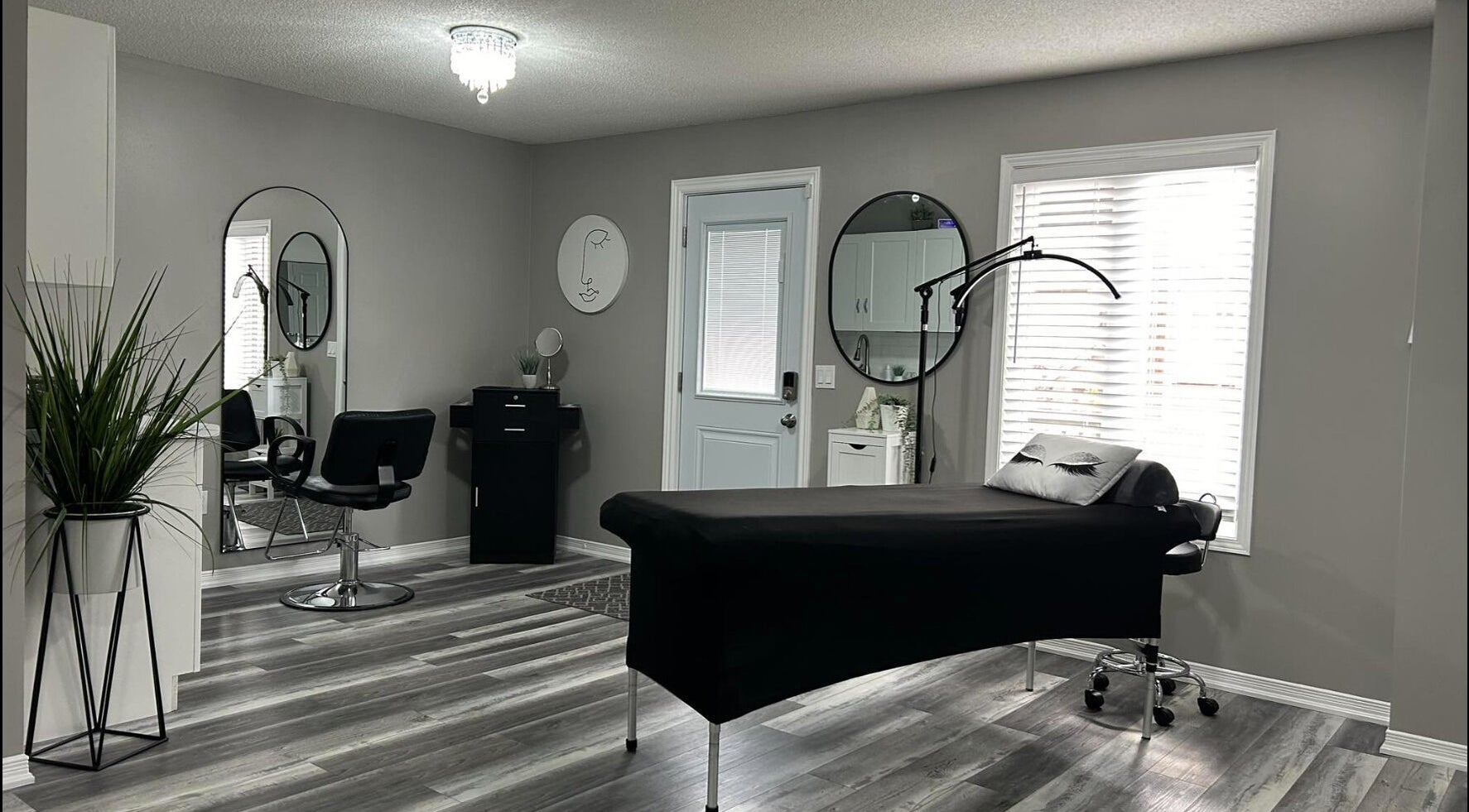 Modern aesthetic room at Endulgence Esthetics, London, Ontario, CA, featuring sleek styling chair and treatment bed.
