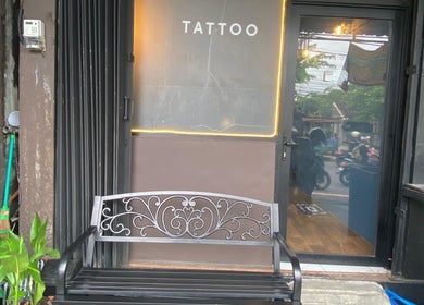 Entrance of Devarda INK Tattoo Studio in Bali, Bali, ID, showcasing a stylish bench and glass door.