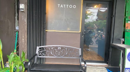 Entrance of Devarda INK Tattoo Studio in Bali, Bali, ID, showcasing a stylish bench and glass door.