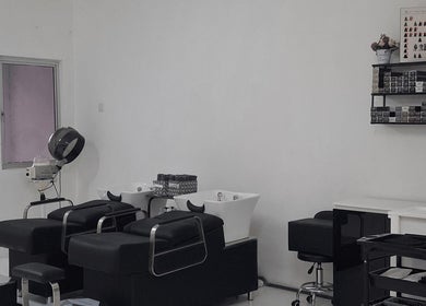 Modern salon with sleek furnishings at Mekar Anggun Salon, Kuantan, Pahang, MY, showcasing stylish hair stations.