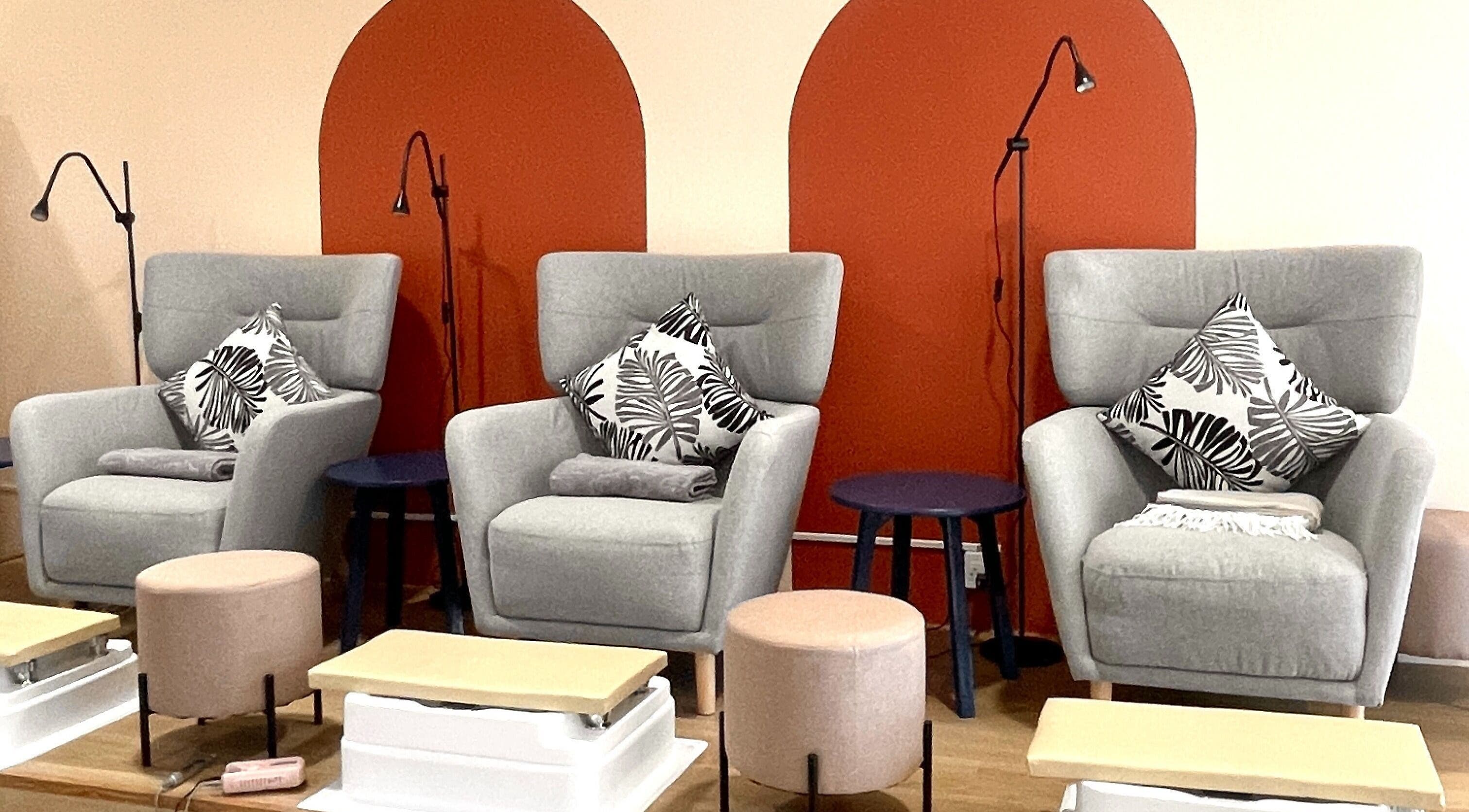 Modern nail salon seating at Nails & Ales Studio, Krung Thep Maha Nakhon, TH, with stylish gray chairs.