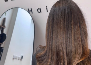Stylish brunette hairstyle at Mocha Hair salon in South Croydon, England, GB, showcasing sleek and glossy hair.