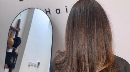 Stylish brunette hairstyle at Mocha Hair salon in South Croydon, England, GB, showcasing sleek and glossy hair.