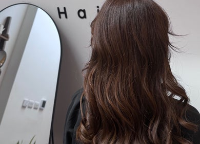 Brunette hair styled at Mocha Hair, South Croydon, England, GB in front of salon mirror.