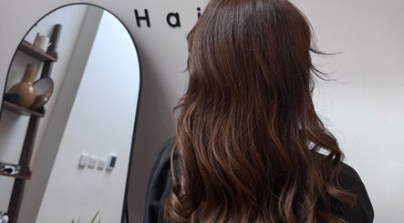 Brunette hair styled at Mocha Hair, South Croydon, England, GB in front of salon mirror.