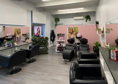 Modern salon interior at Katy & Co. Hair, Engadine, New South Wales, AU. Stylish chairs and vibrant decor.