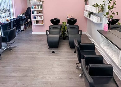 Modern interior of Katy & Co. Hair, Engadine, New South Wales, AU, showcasing stylish salon chairs and vibrant decor.