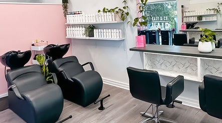Modern salon setup at Katy & Co. Hair, Engadine, New South Wales, AU, featuring stylish chairs and decor.