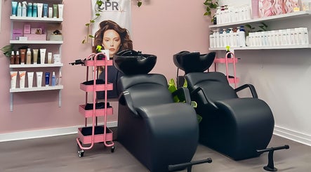 Stylish hair wash stations at Katy & Co. Hair, Engadine, New South Wales, AU with shelves of hair products.