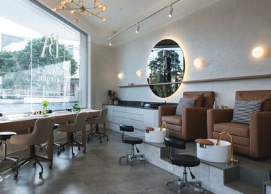 Stylish salon interior at Cosmetics by Nurse Juliette, Alexandria, New South Wales, AU, with plush seating.