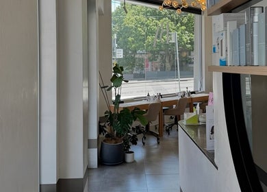 Bright, modern interior of Cosmetics by Nurse Juliette in Alexandria, New South Wales, AU with stylish seating.