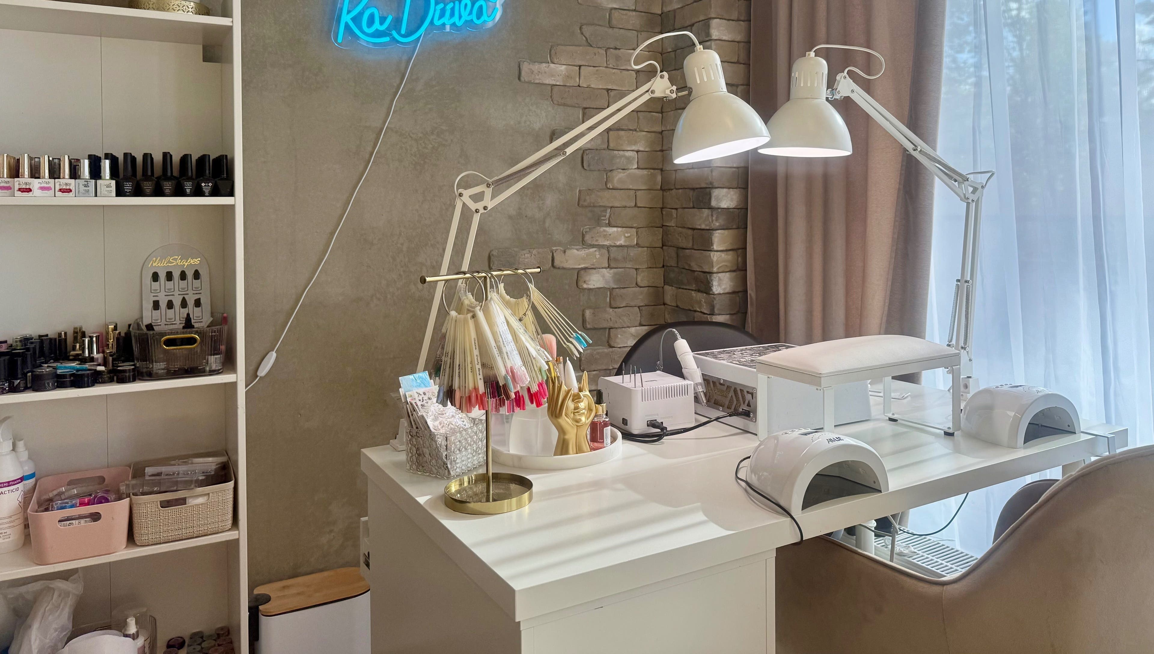 Chic nail workspace at Ka Diiva, Tallinn, Harju maakond, EE features modern lamps and polish displays.