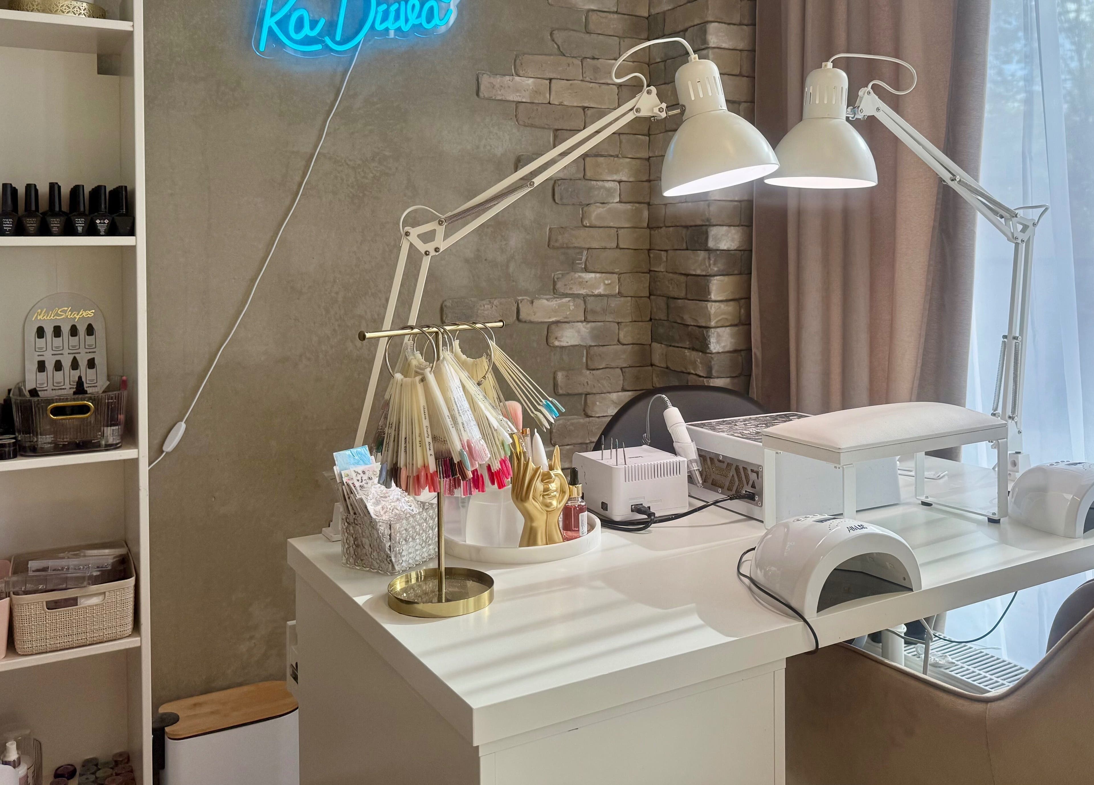 Chic nail workspace at Ka Diiva, Tallinn, Harju maakond, EE features modern lamps and polish displays.