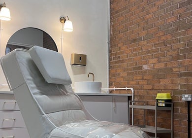 Modern treatment room at NL Aesthetics, Worcester, England, GB featuring a plush chair and elegant decor.
