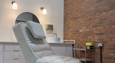 Modern treatment room at NL Aesthetics, Worcester, England, GB featuring a plush chair and elegant decor.