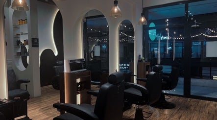 Modern interior of Lasgidi BarberShop, مسقط, Muscat Governorate, OM - stylish grooming chairs and decorations.