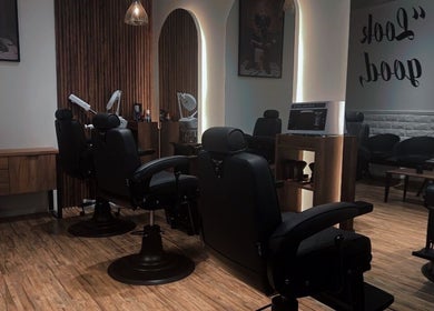 Chic interior of Lasgidi BarberShop in مسقط, Muscat Governorate, OM featuring sleek black barber chairs.