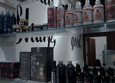 Shelf of grooming products at Lasgidi BarberShop, مسقط, Muscat Governorate, OM, showcasing premium care.