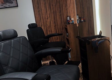 Sophisticated barber chairs at Lasgidi BarberShop, مسقط, Muscat Governorate, OM with modern decor.