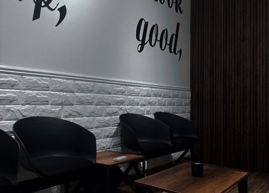 Seating area at Lasgidi BarberShop, Muscat Governorate, OM showcasing modern chairs and stylish decor.