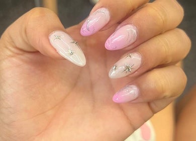 Elegant nail art with pink gradient and star designs at Madelyn Chicago Nail Spa, Chicago, Illinois, US.