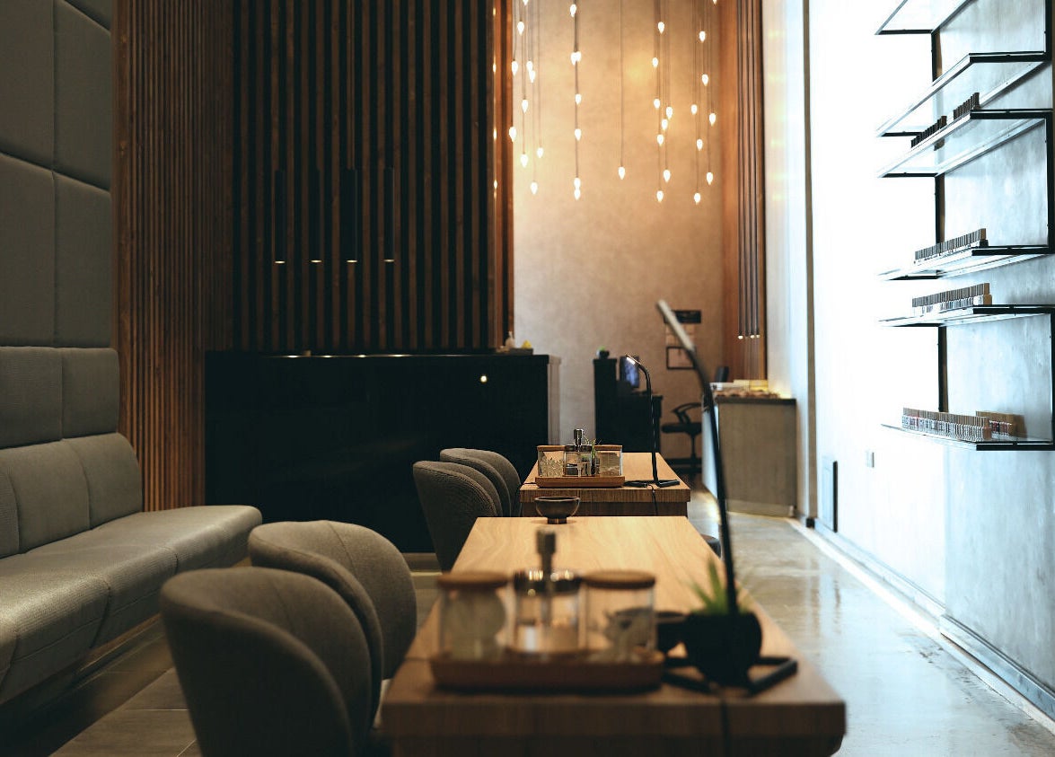 Modern lounge at Beauty Box Nail Spa & Salon in Dhahran, SA, featuring elegant chairs and sleek decor.