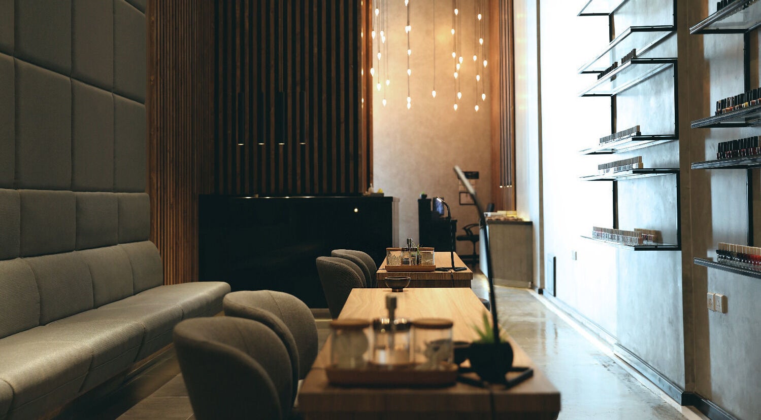 Modern lounge at Beauty Box Nail Spa & Salon in Dhahran, SA, featuring elegant chairs and sleek decor.