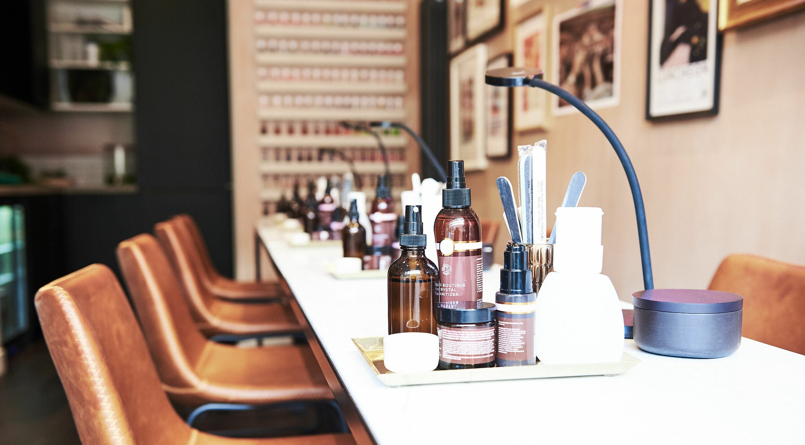Luxurious salon setup at AMA Brixton, London. Elegant products and seating enhance wellness experience.