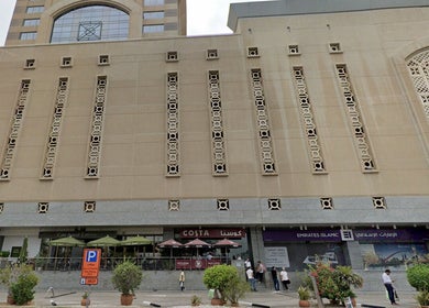Exterior of building housing Aura Blend Ladies Salon in Dubai, Dubai, AE, showcasing modern architectural design.