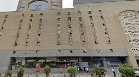 Exterior of building housing Aura Blend Ladies Salon in Dubai, Dubai, AE, showcasing modern architectural design.