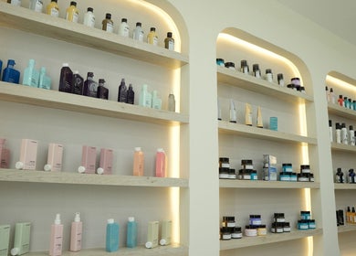 Product display at Aura Blend Ladies Salon, showcasing beauty essentials on lit shelves in Dubai, Dubai, AE.