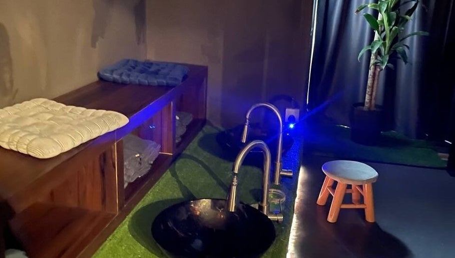 Relaxing foot bath area at Foot Magic Reflexology, SERI KEMBANGAN, Selangor, MY, featuring comfortable seating.