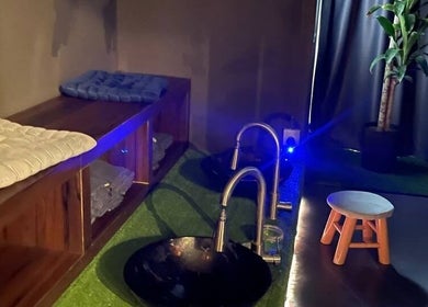 Relaxing foot bath area at Foot Magic Reflexology, SERI KEMBANGAN, Selangor, MY, featuring comfortable seating.