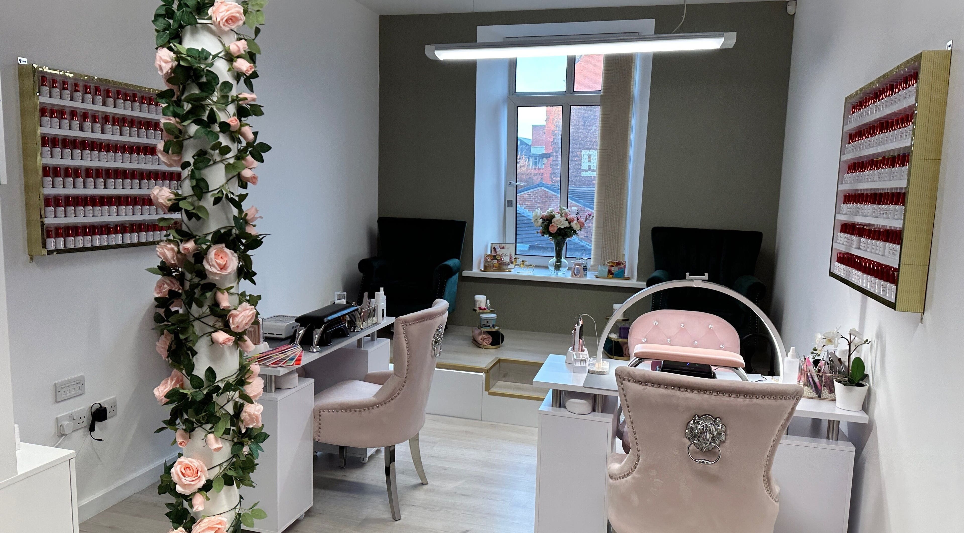 Beautiful interior of Eleganza Nails, Manchester, England, GB, showcasing chic decor and nail polish display.