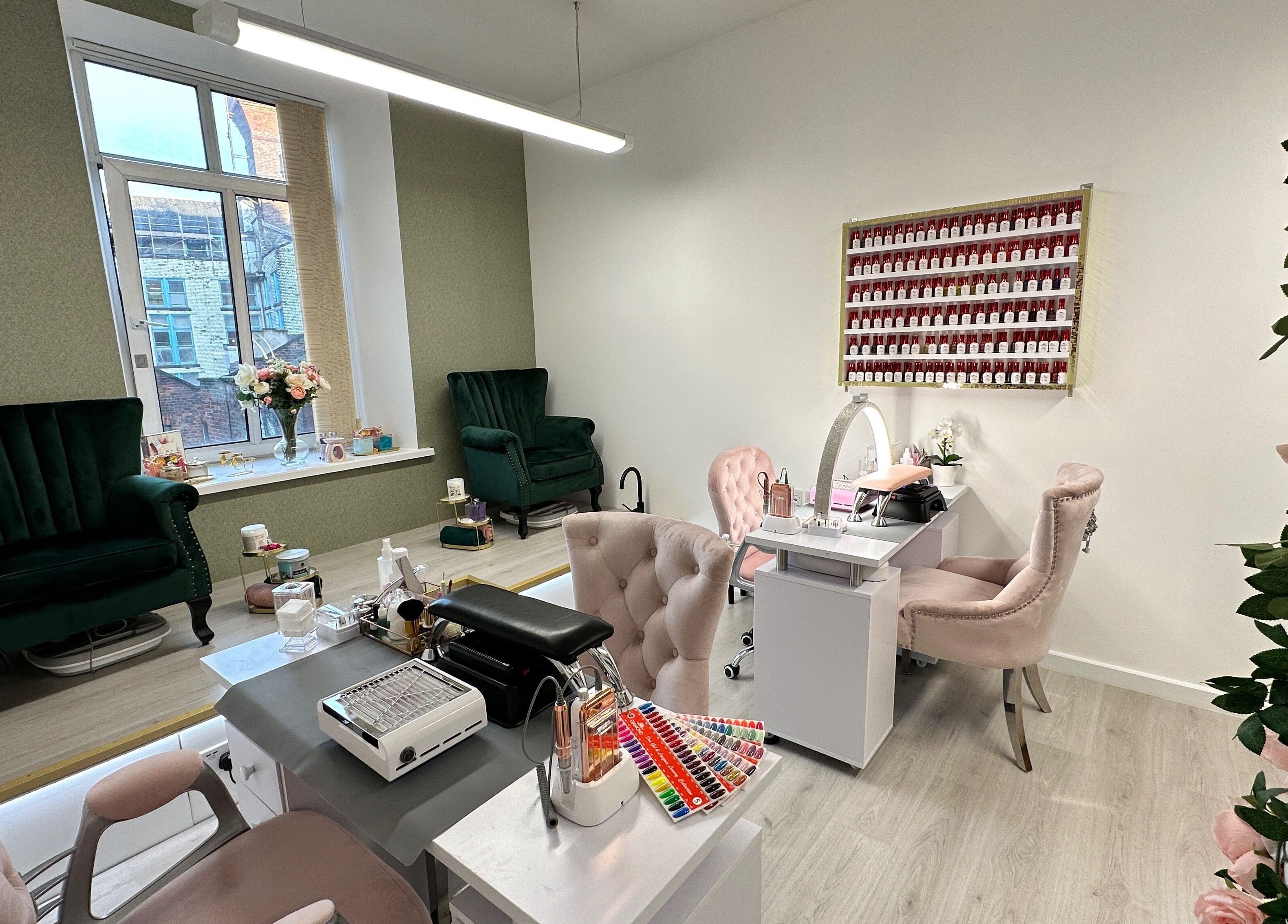 Chic interior of Eleganza Nails in Manchester, England, GB with plush chairs and nail polish display.