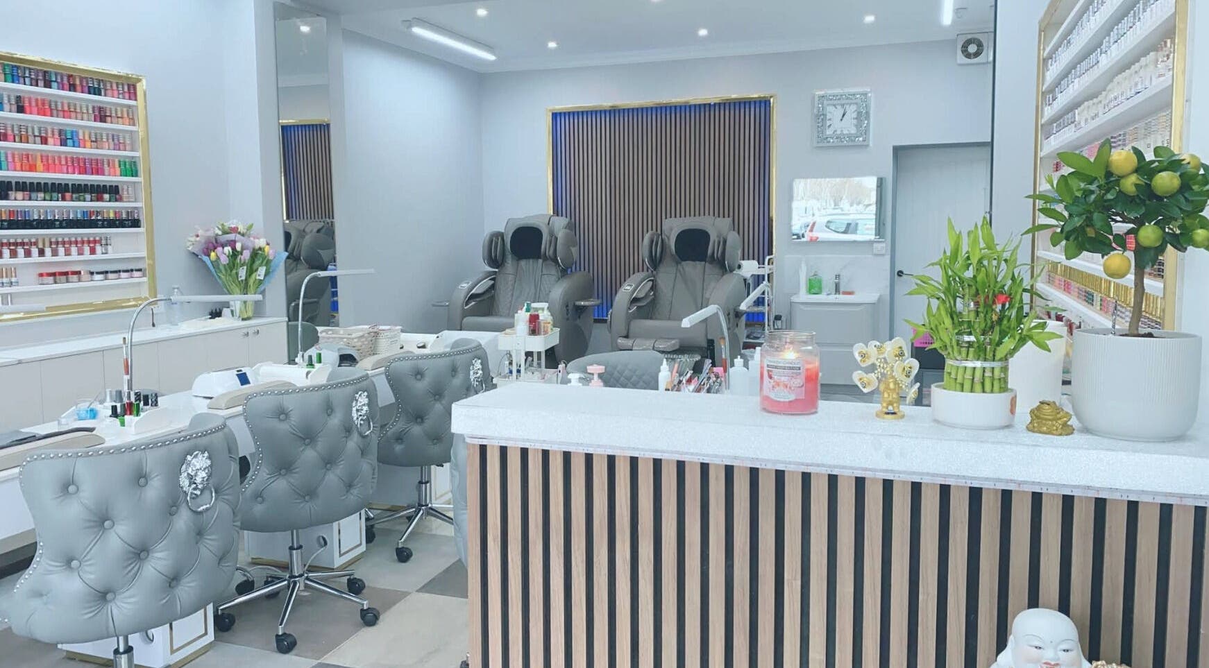 Elegant nail salon interior at Amy Nails, Enfield, England, GB featuring plush chairs and vibrant decor.