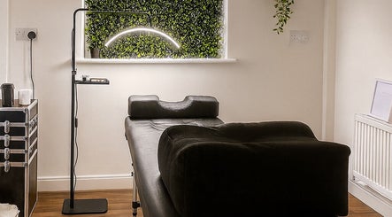 LASHD treatment room with massage bed and plant decor in Salford, England, GB.