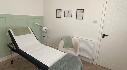 Treatment room at Flawless in Lostock Hall, England, GB featuring a massage bed and calming decor.